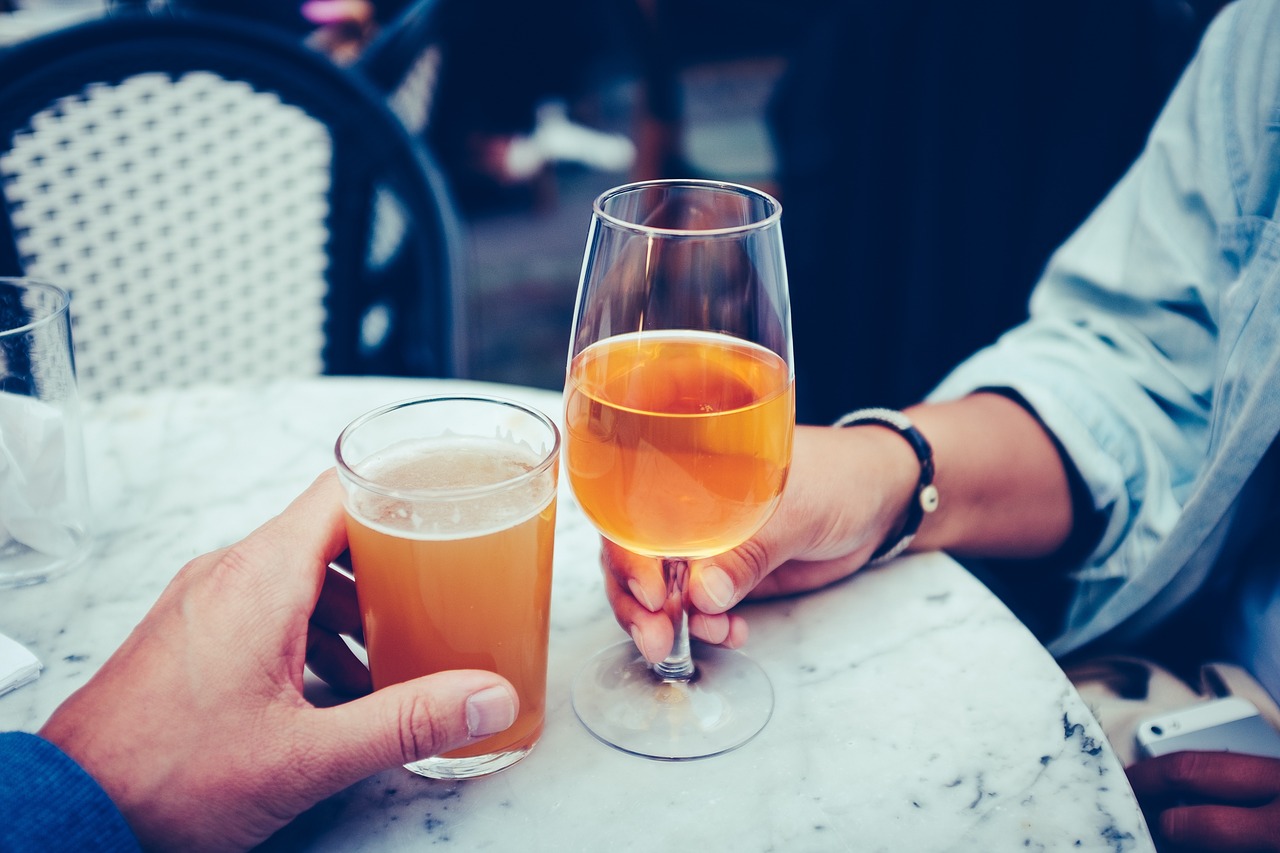 Two people cheering their beers